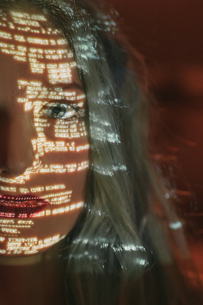 our-experience Abstract cyberpunk portrait with code projected on a woman's half face, symbolizing technology integration.