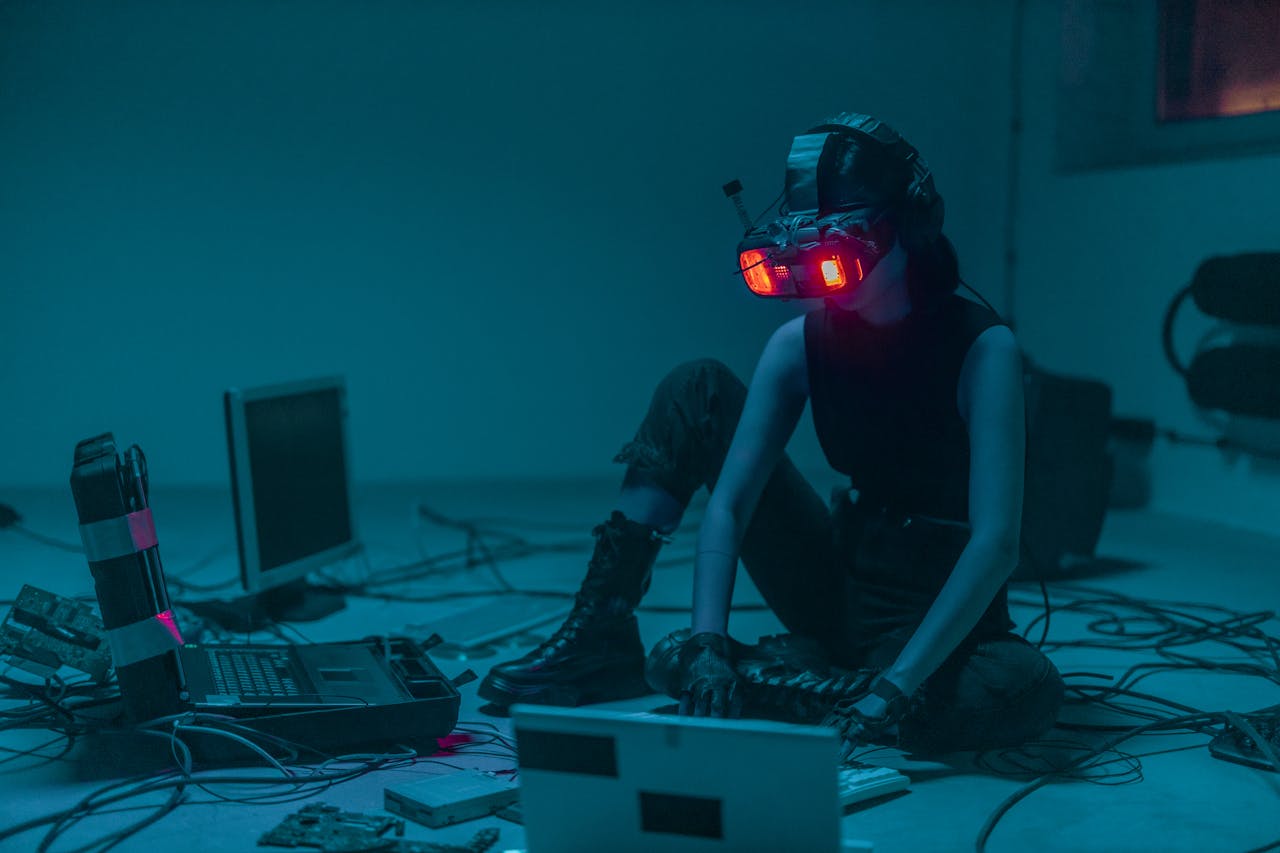 about-02 A person in a VR headset hacking in a moody, neon-lit environment.